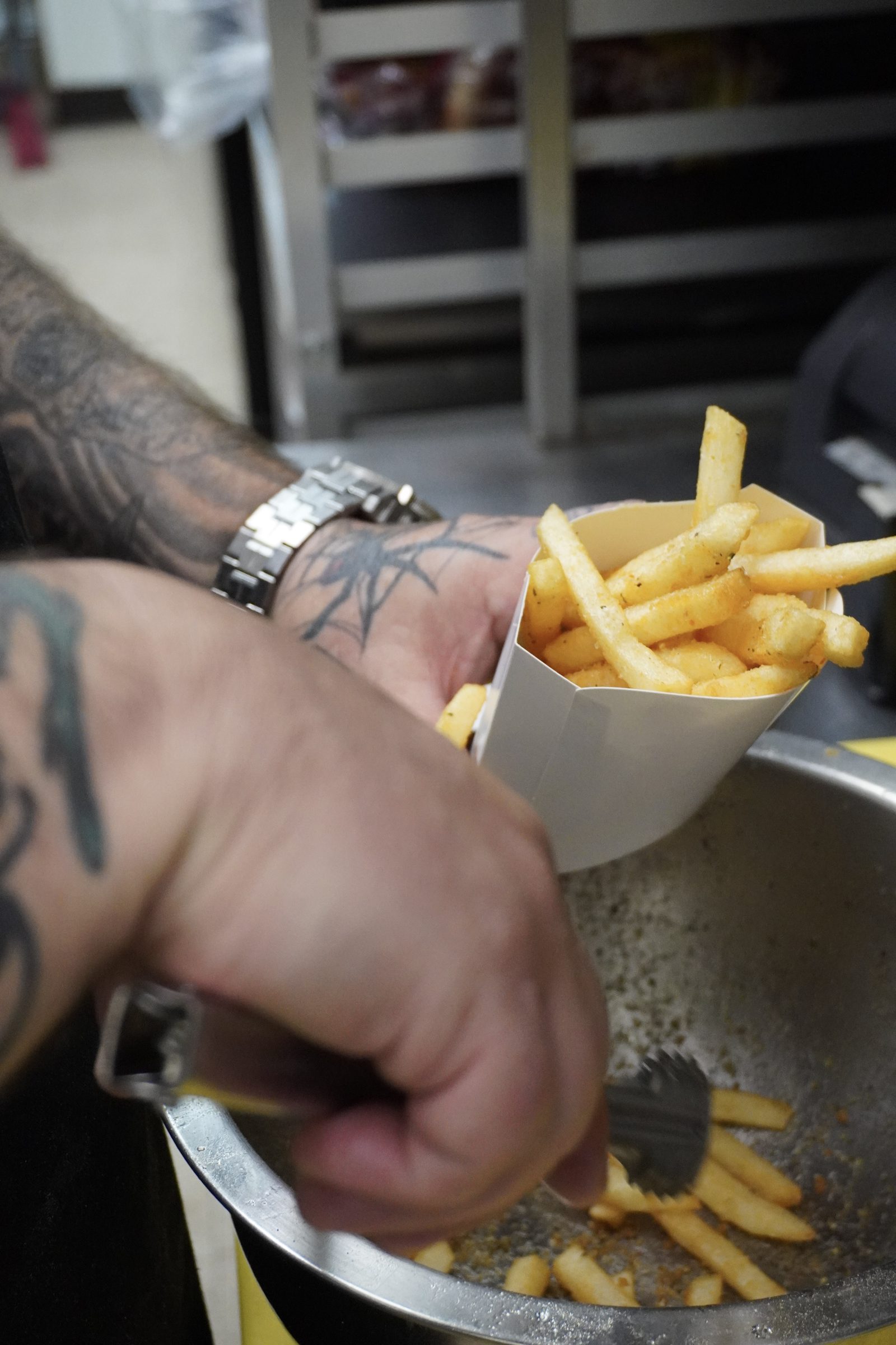 Fresh fries scooped to order behind the counter at Sak's Deli in Clayton NC