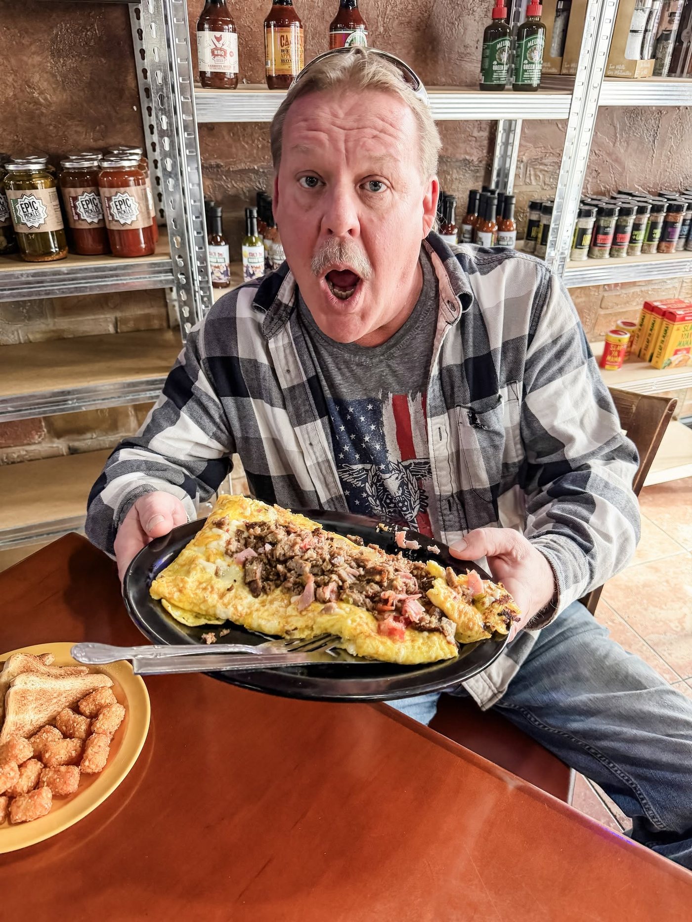 Customer wide-eyed over a giant omelette at Sak's Deli